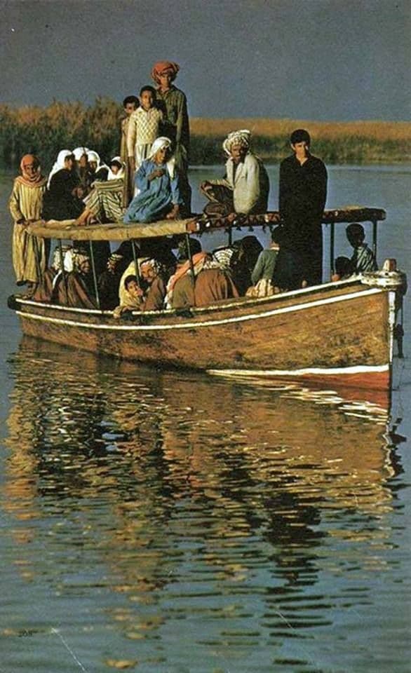 Ma'dan families aboard a traditional boat on the marshes, 1977